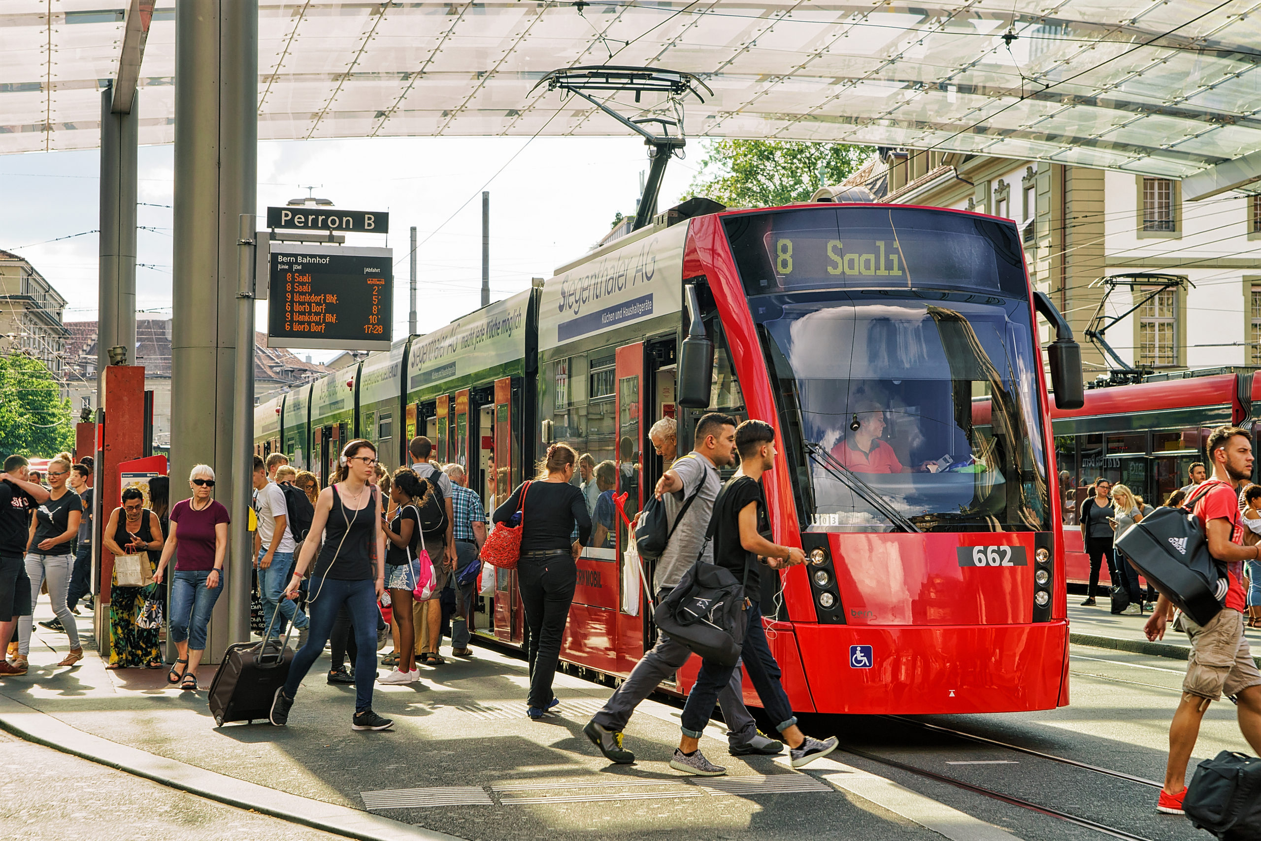 Passengers and tram at railway station Bahnhofplatz Bern Swiss