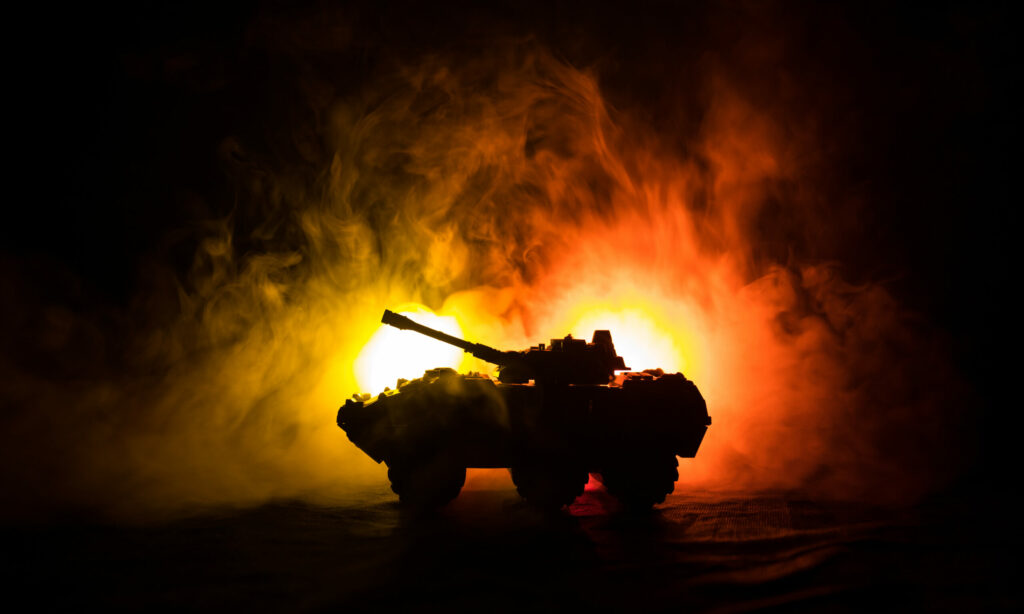 War Concept. Military silhouettes fighting scene on war fog sky background, World War German Tanks Silhouettes Below Cloudy Skyline At night. Attack scene. Armored vehicles.