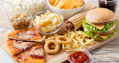 close up of fast food snacks and drink on table