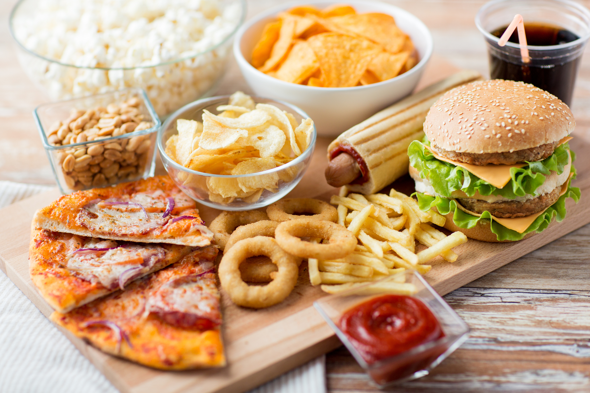 close up of fast food snacks and drink on table