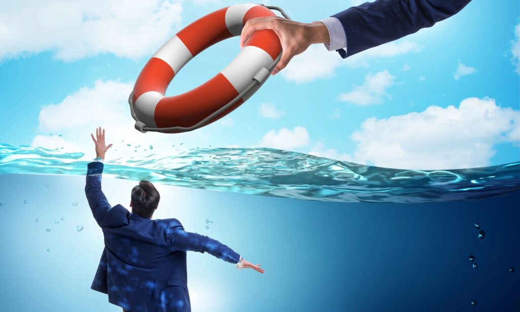 Businessman being saved from drowning