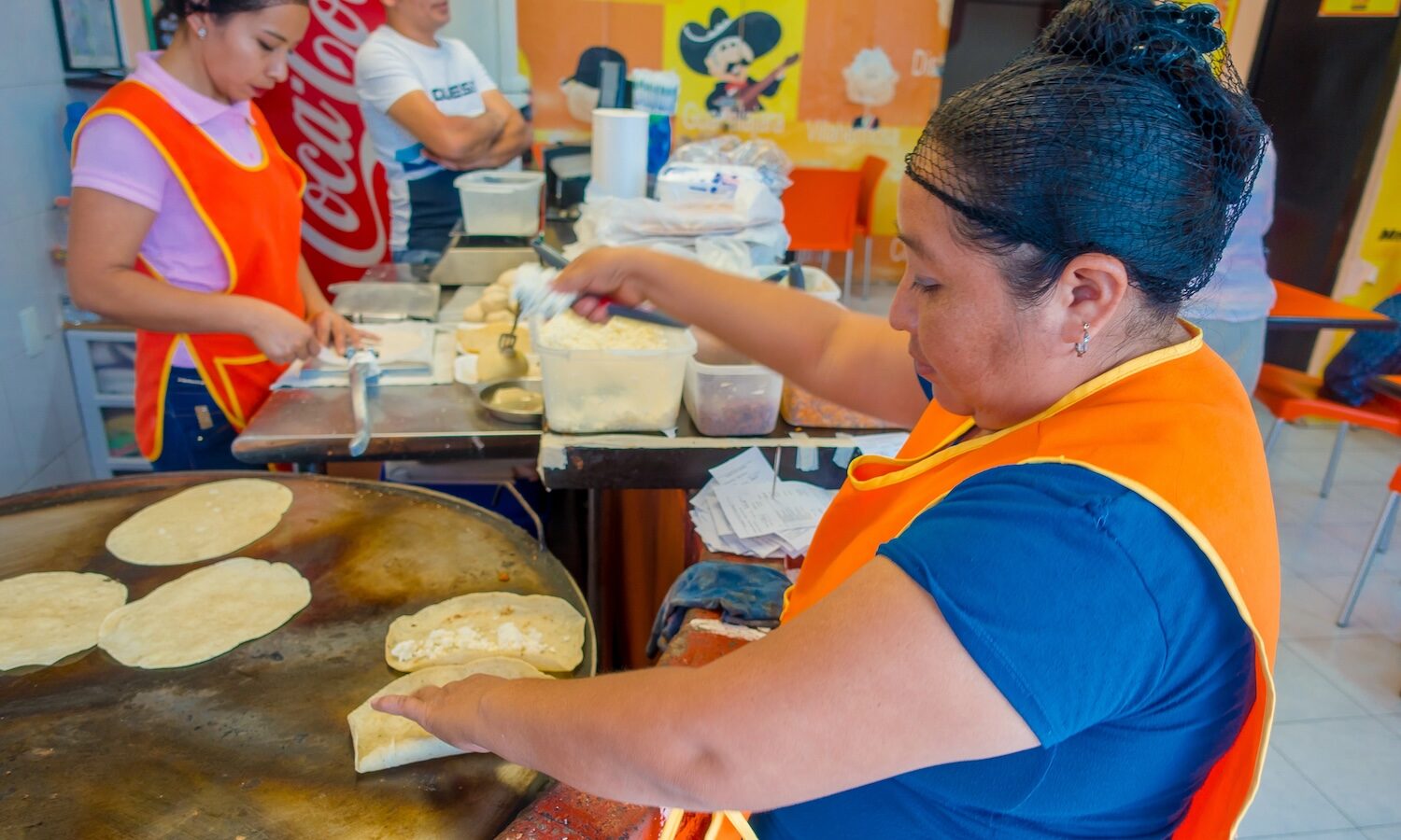 TULUM, MEXICO - JANUARY 10, 2018: Unidentified woman worker making corn tortillas in Mexico