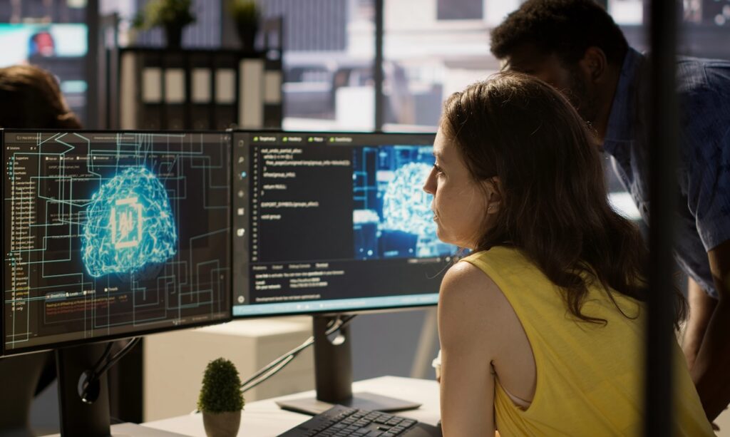 Employee using AI technology to design machine learning algorithms