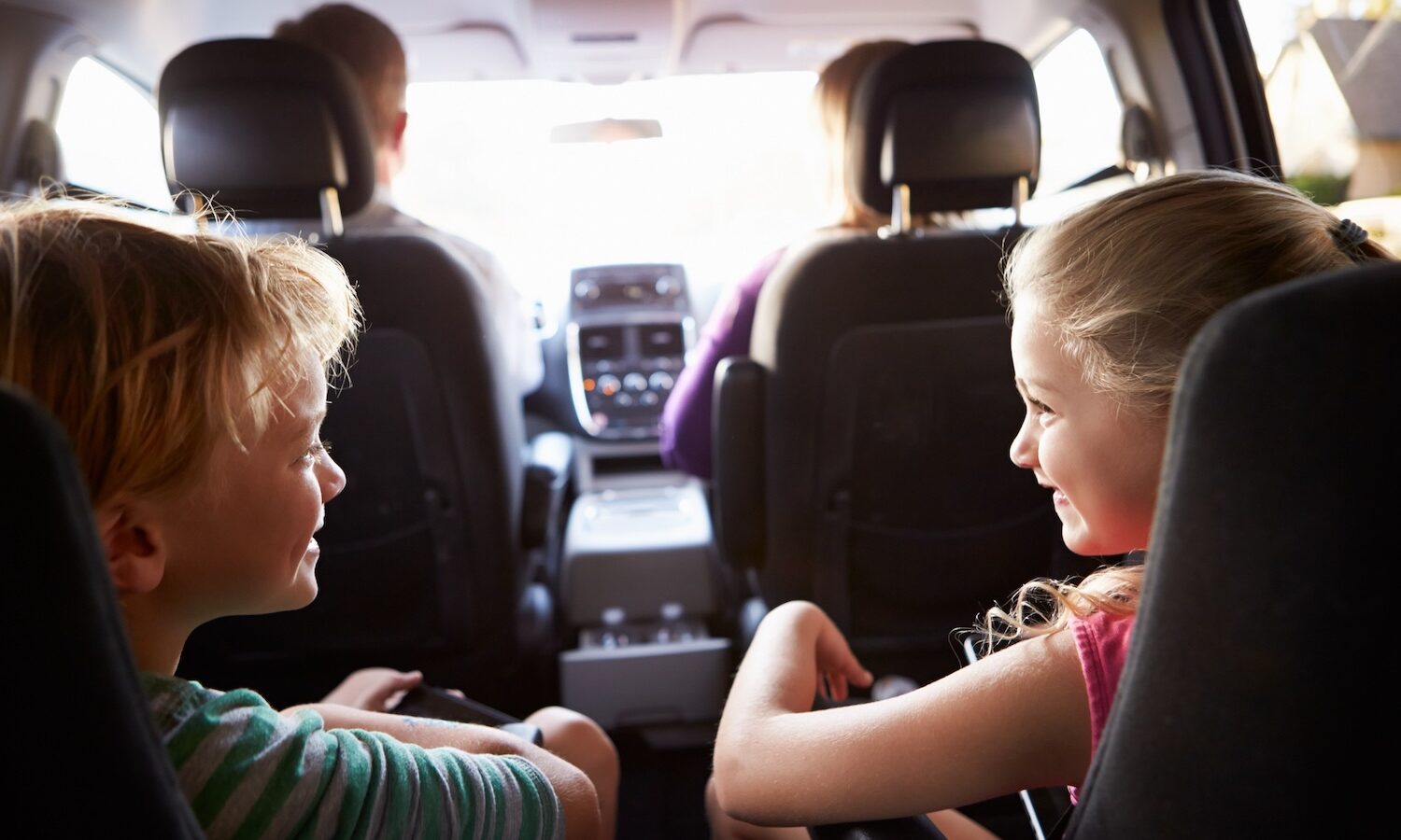 Children In Back Seat Of Car On Journey With Parents