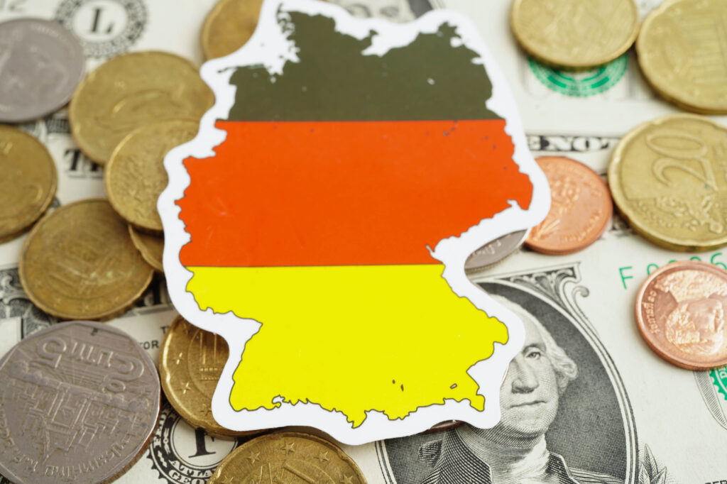 German flag on coin and banknote money, finance trading investme