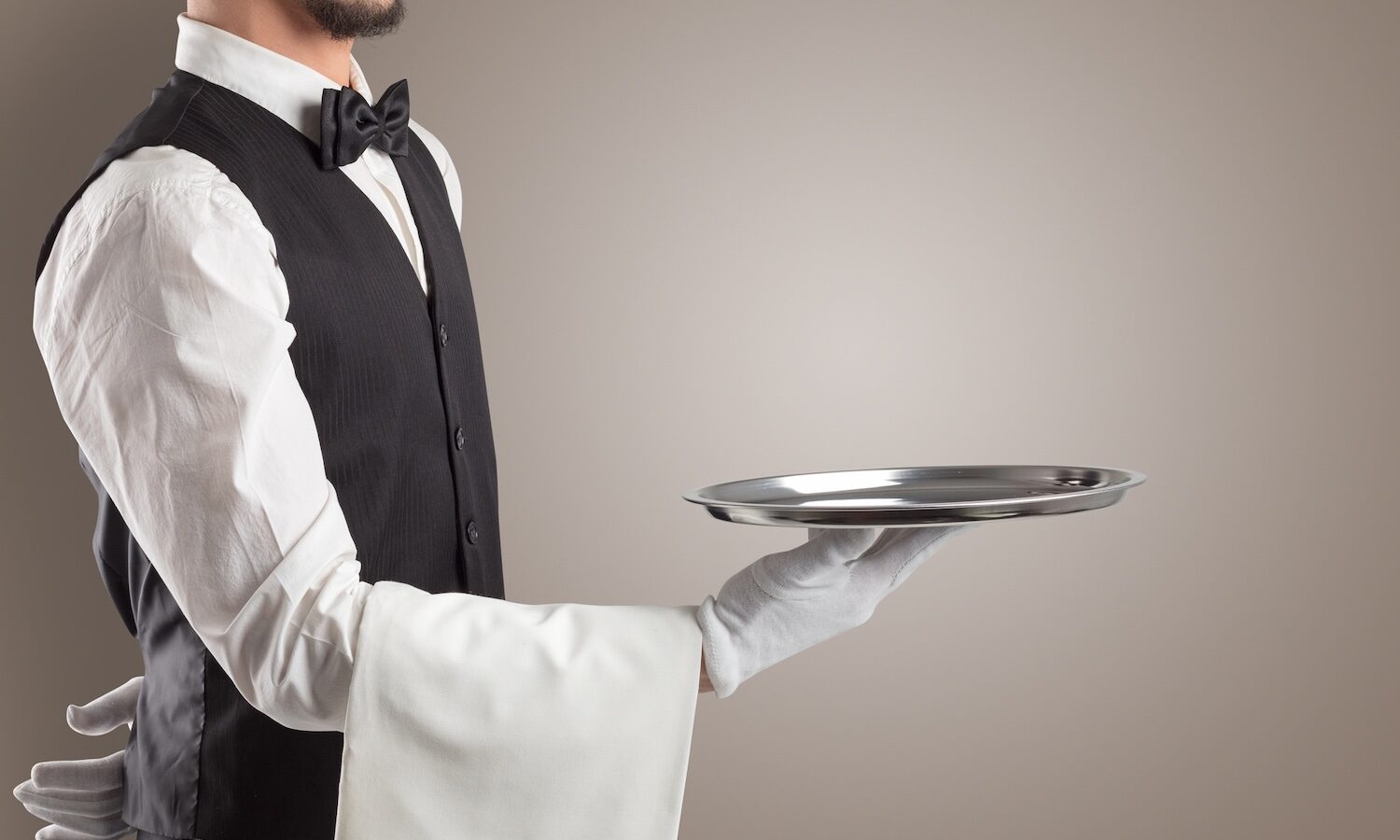 Waiter serving with white gloves and steel tray