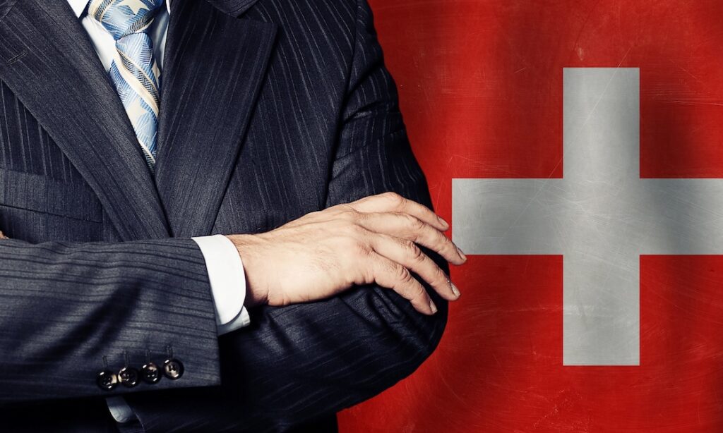 Politician crossed arms of on Swiss flag background
